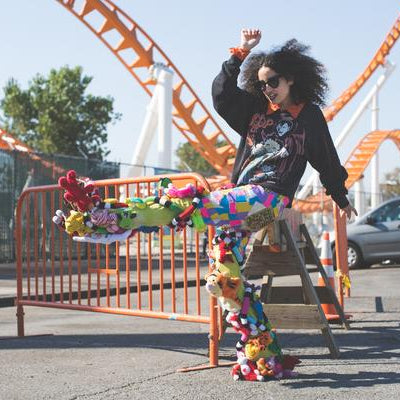 model wearing stuff toys sewn on pants. 