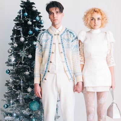 models pose in front of christmas tree. 