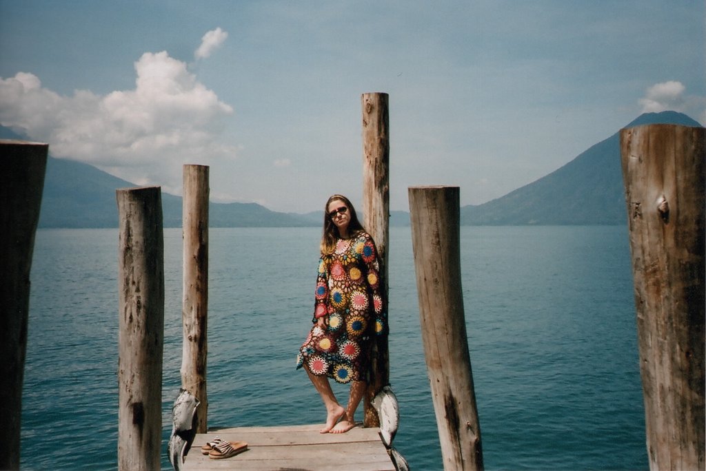 person with crochet dress standing on a dock.