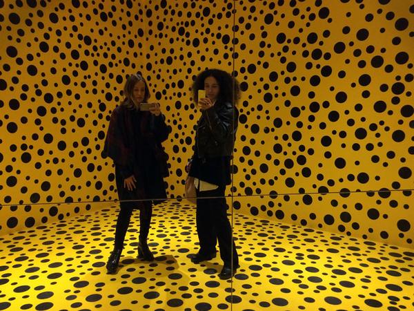 selfie in the mirror of sheyla and rachel in room with yellow and black dots.