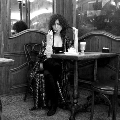 model seated at diner eatting pie. 