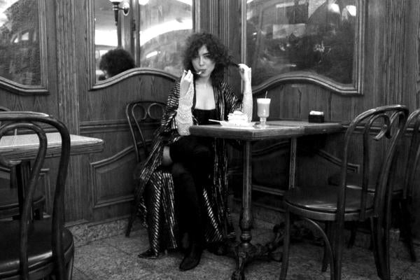 model seated at diner eatting pie. 