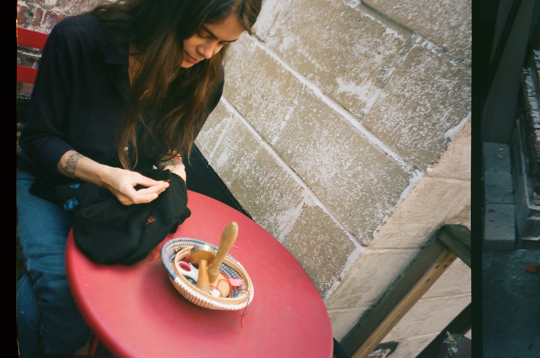 rachel meade daring at table on patio. 