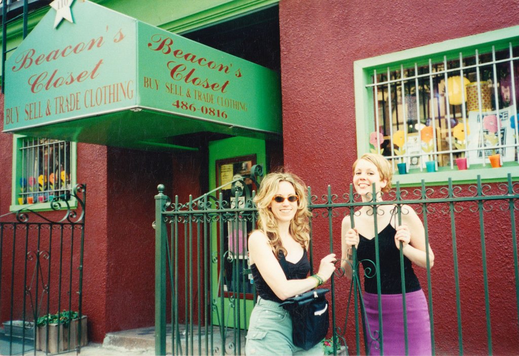 carrie and friend in front of original store front, awning reads beacon's closet buy sell trade 486-0816.