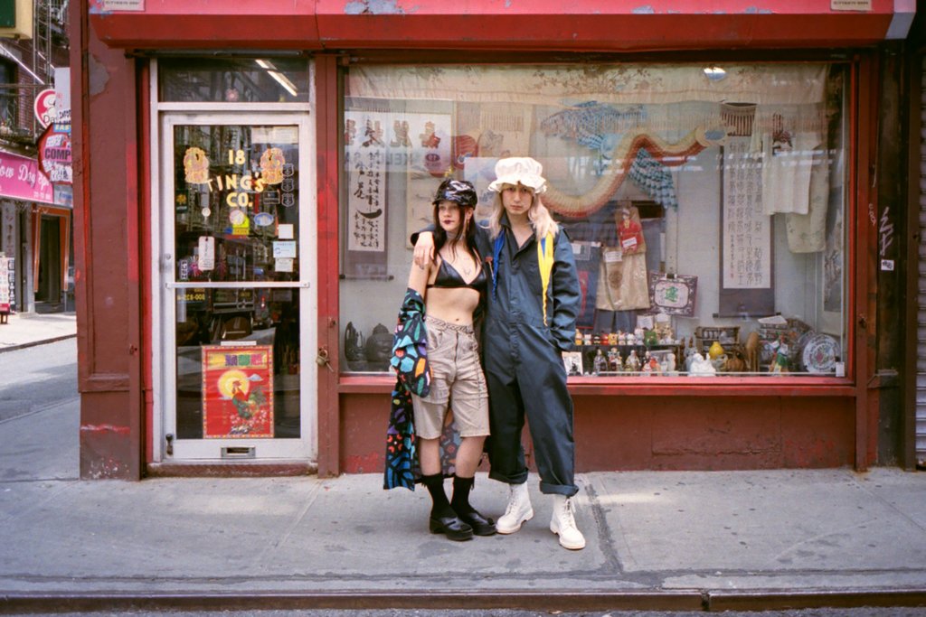 models posing in front of store front 18 ting co. 