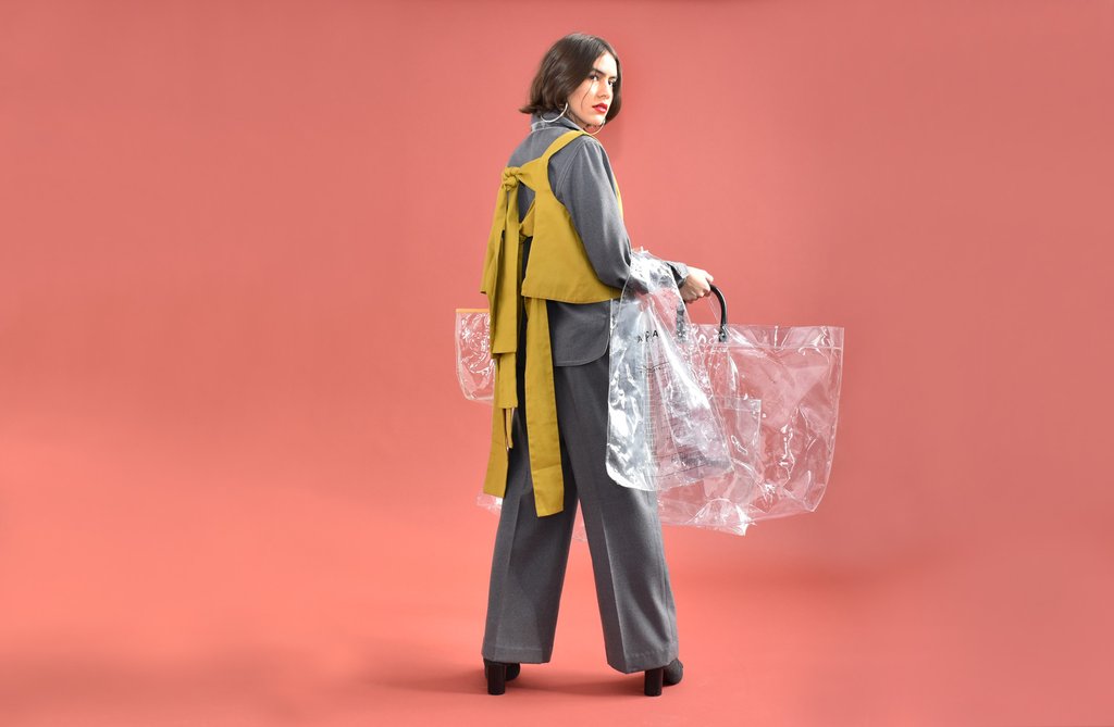 model with a collection of clear bags. 