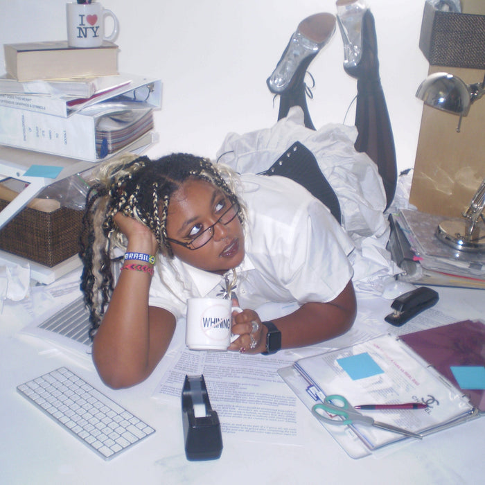 fun office siren editorial image of model laying amongst office supplies