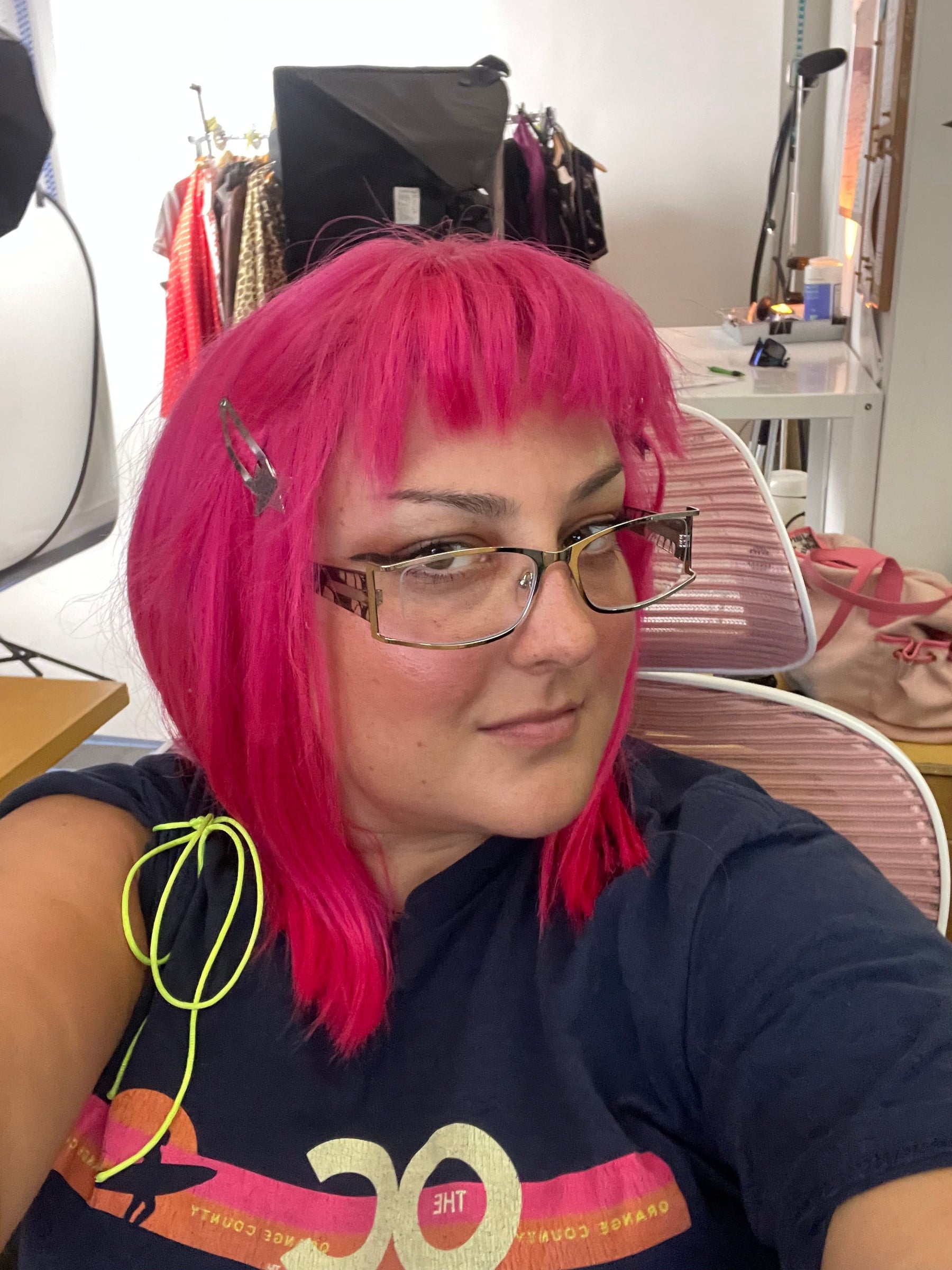 selfie of delcey sitting at desk behin product studio