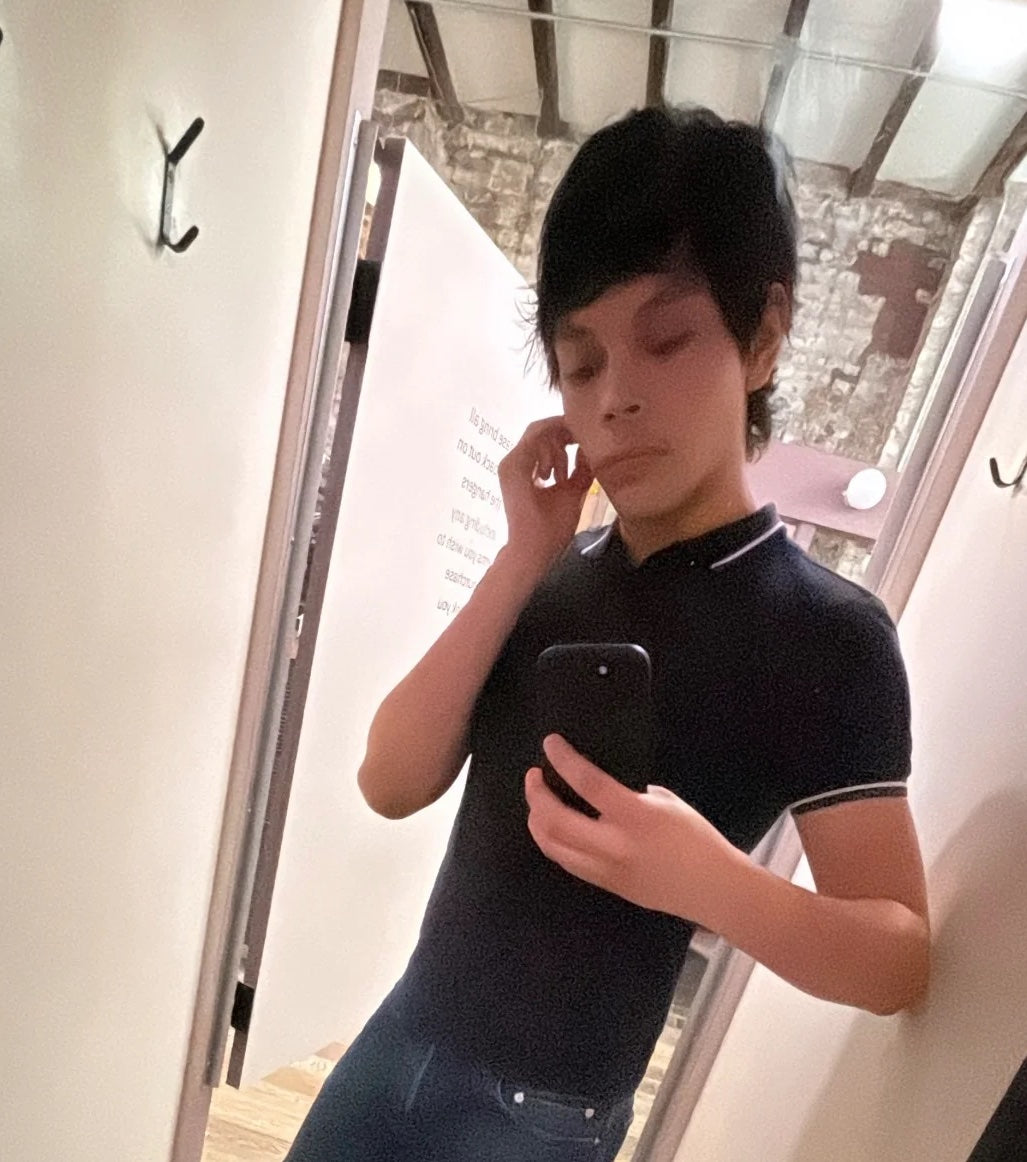 cropped selfie of jacob in fitting room mirror