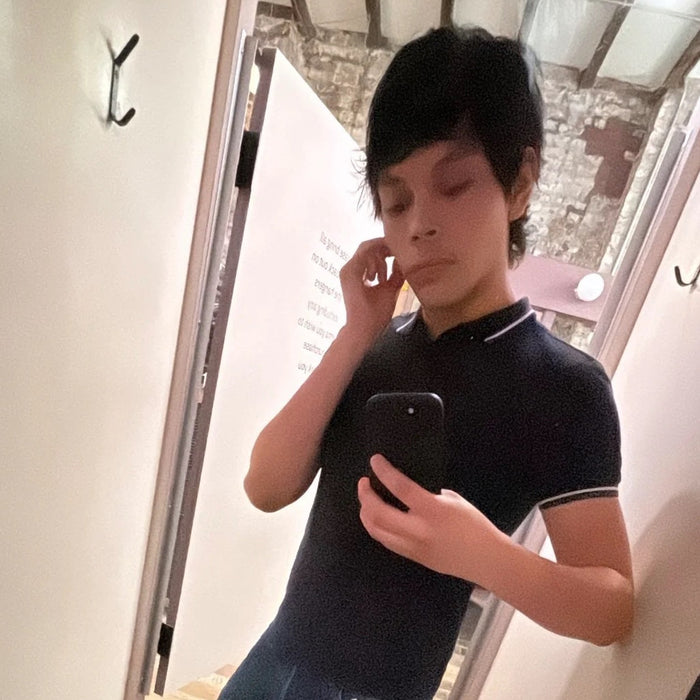 cropped selfie of jacob in fitting room mirror