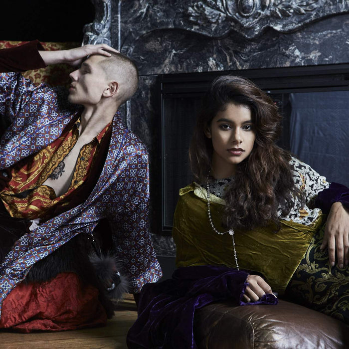 models posing in mixed prints lounging in front of a fire place