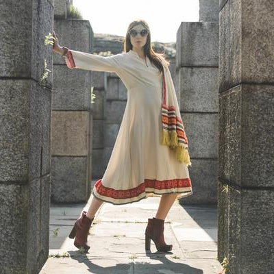 model posing in folk inspired dress.