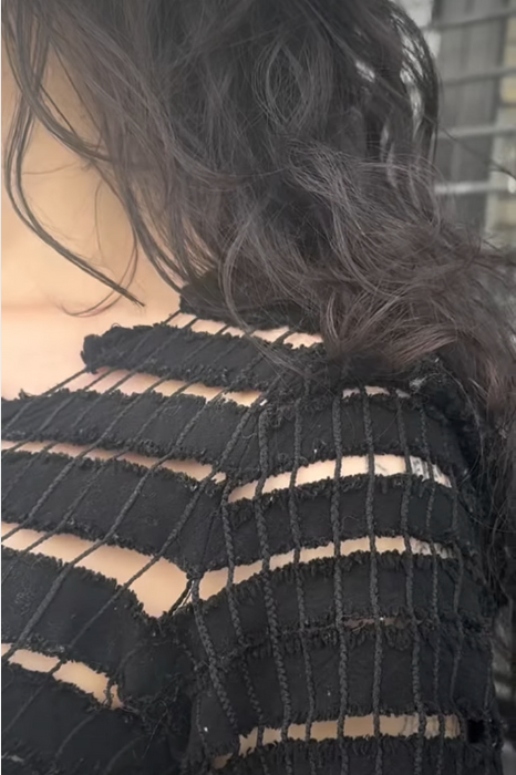 screen shot from featured reel. model wearing open knit top