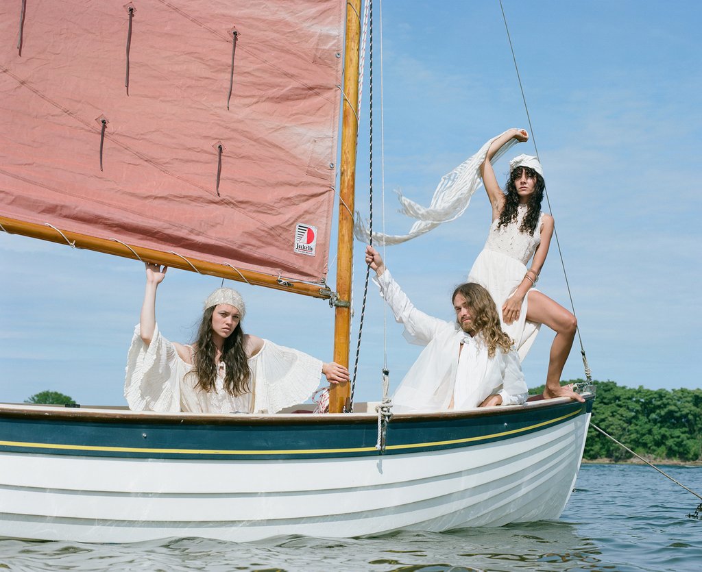 three models on sail boat. 