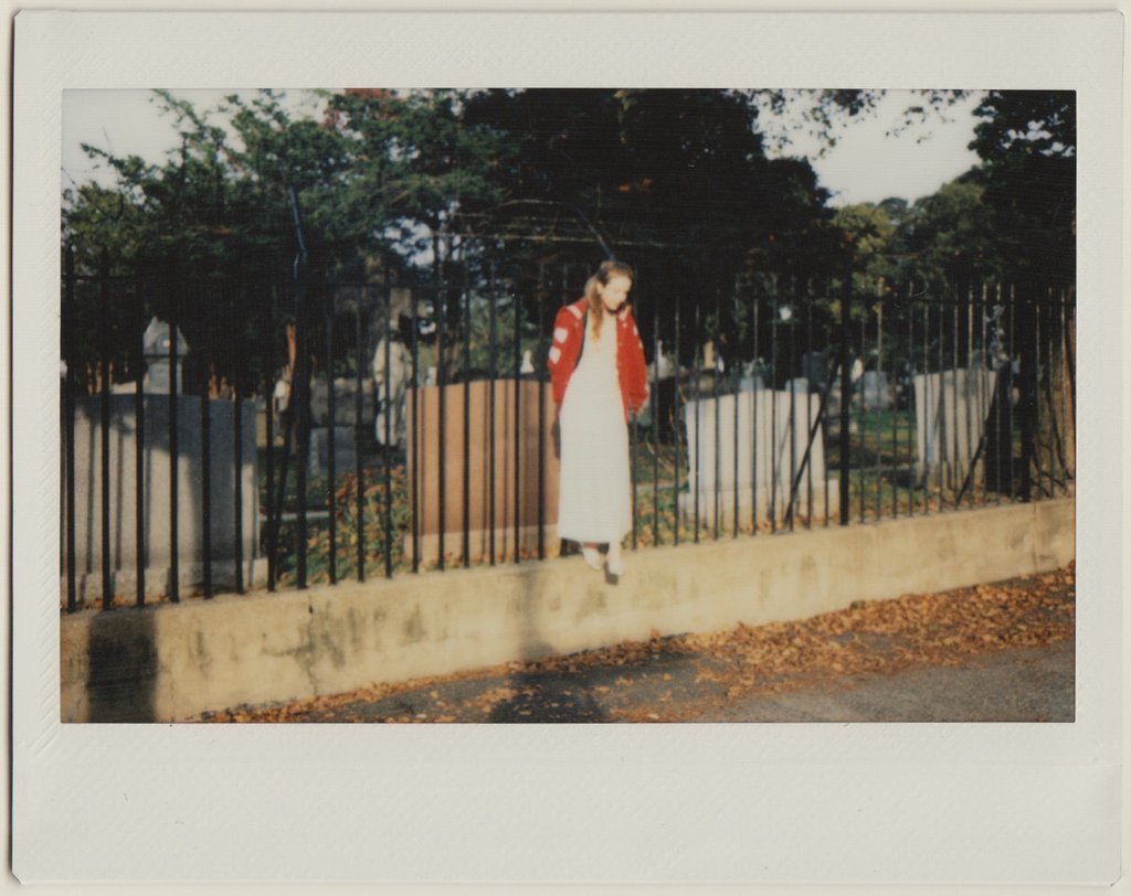 polaroid in front of cemetery. 