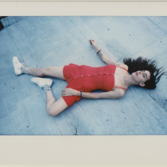 polaroid of phaedra laying on their roof. 