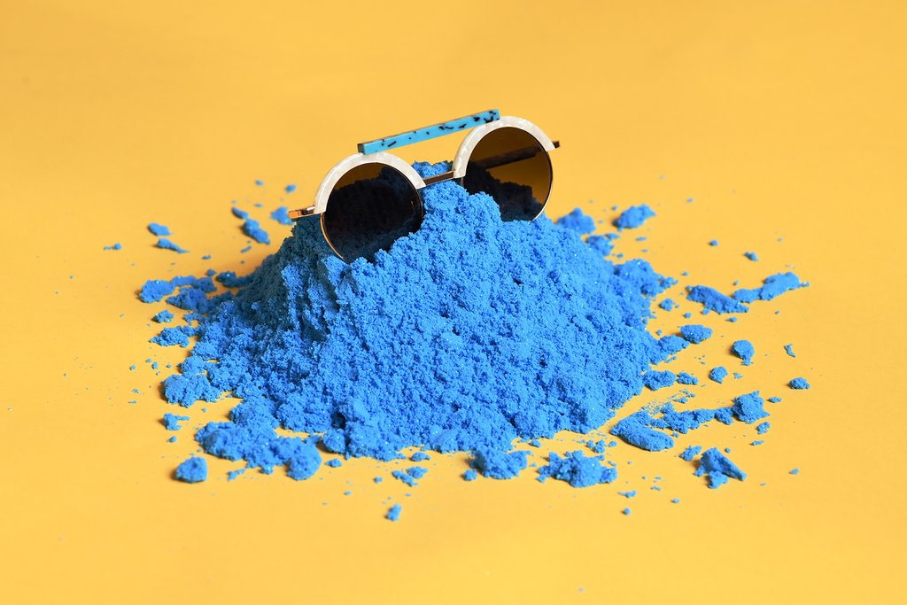 still life of sunglasses in kinetic sand.