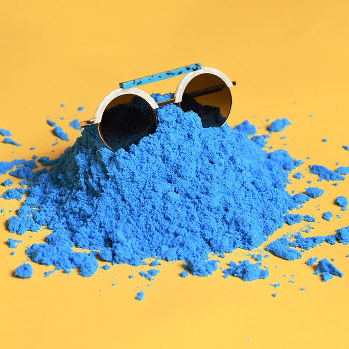 still life of sunglasses in kinetic sand.