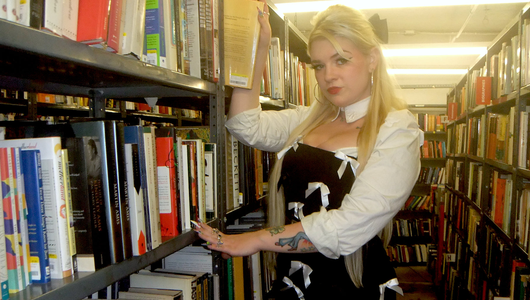 model posing in library aisle 