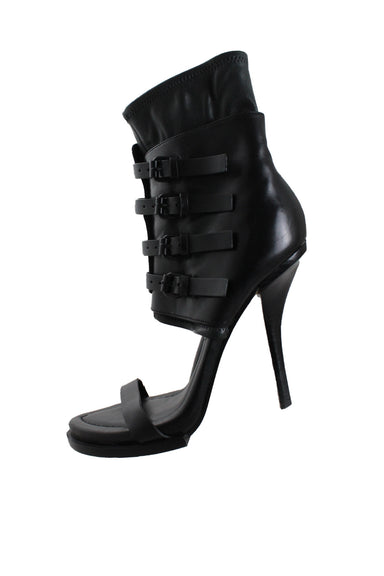 description: alexander wang gladiator black leather sandals. features stiletto heels with platform, wrap-around straps and buckle closure at uppers, pointed toe silhouette, and cushioned sole. 