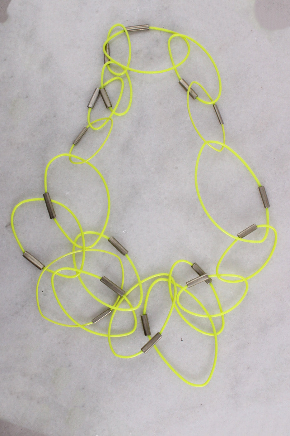 detailed photo of yellow ring necklace.