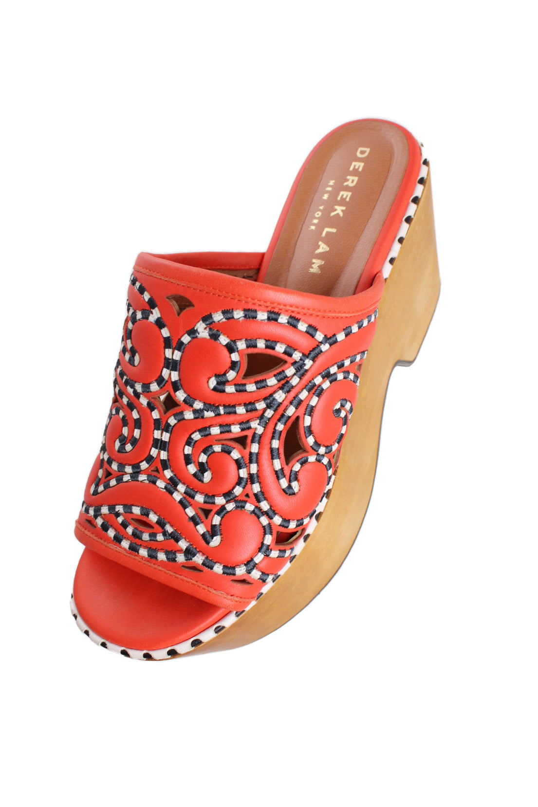 above angle of clogs with arabesque embroidered at top. 