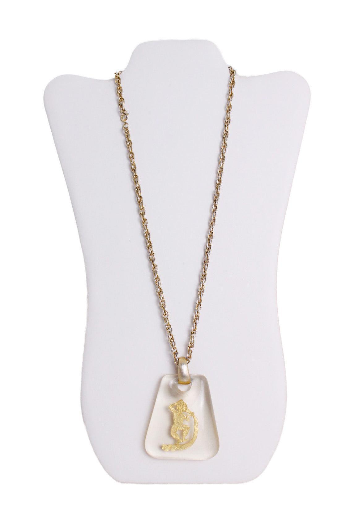 front of vintage gold toned pendant. features transparent acrylic square shape pendant, and gold toned aquarius symbol.