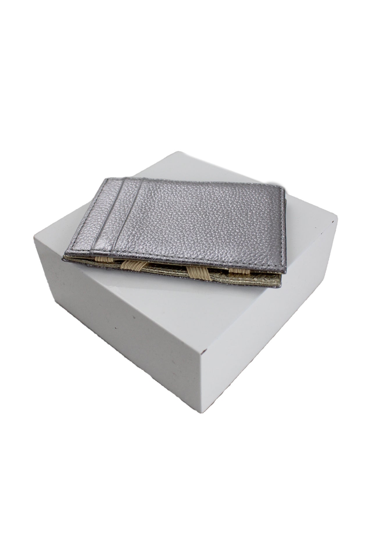 three-quarter side angle j.crew silver and gold faux leather dual card holder on white platform featuring pebbled texture and silver exterior with 3-card slots.