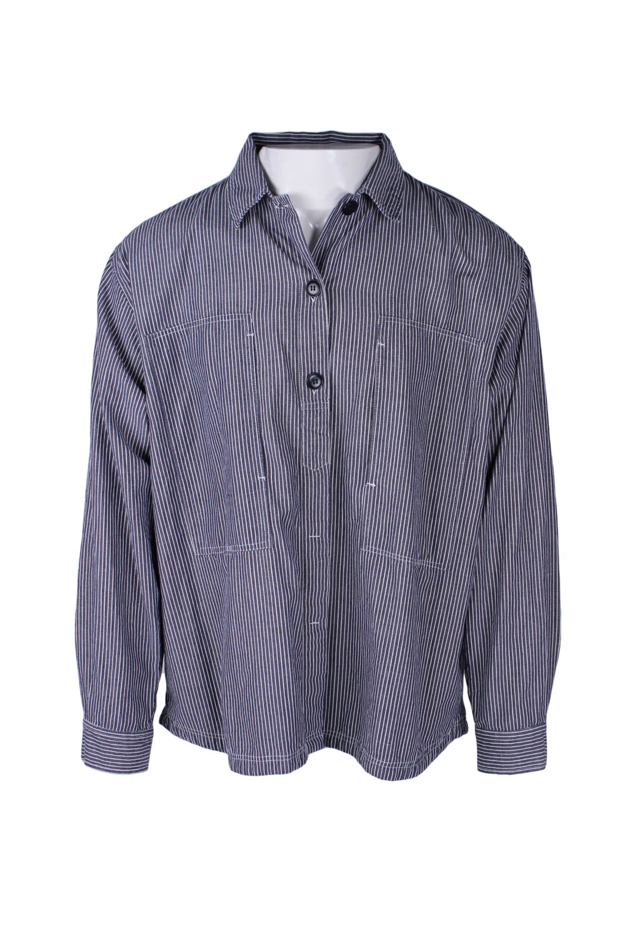 front angle le mont s'michel indigo and white long sleeve workwear inspired striped shirt on masculine mannequin torso featuring oversized vertical chest pockets with decorative topstitching and partially concealed front button closure. 