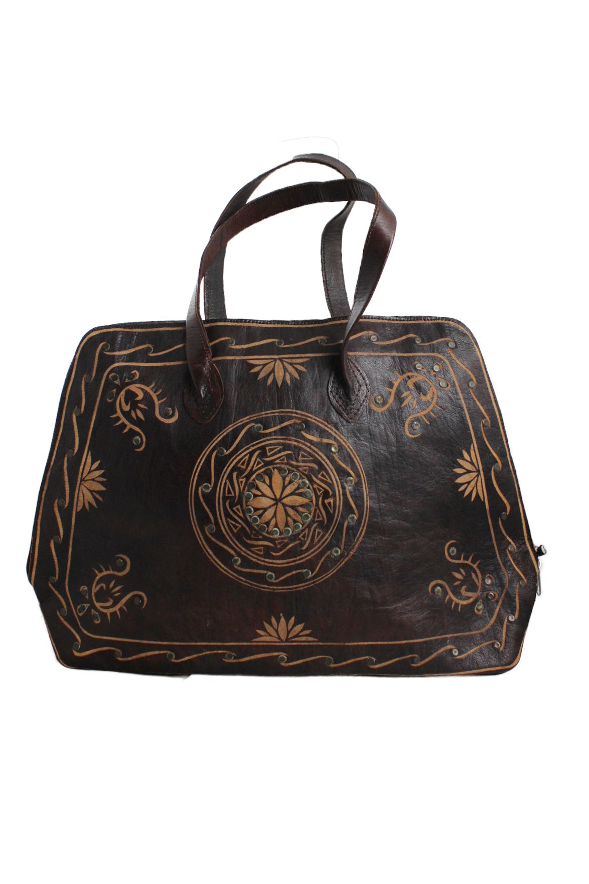 description: vintage unlabeled brown leather tote. features embossed floral design throughout, double strap, fully lined, interior slit pocket and zipper closure at top. 