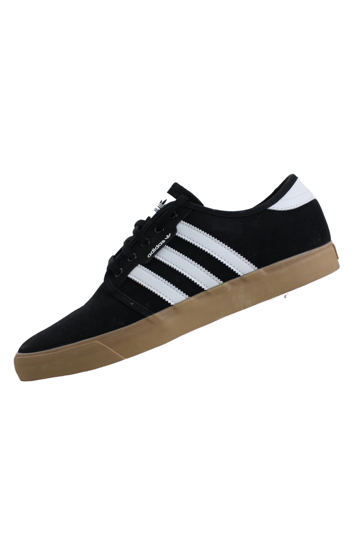 side angle of adidas black/white shoes features ‘adidas’ logo printed at tongue, ‘adidas’ logo tab at sides/back of gum sole, three stripes at sides, and top flat lace closure.