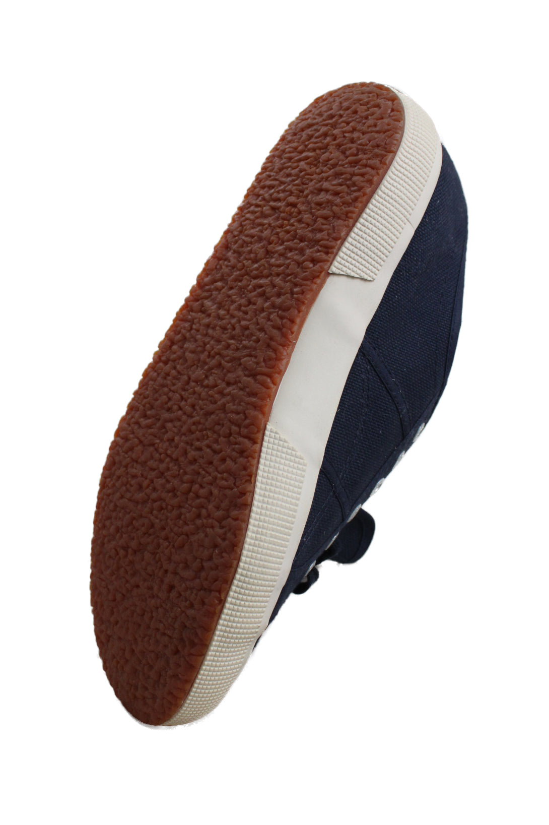 ¾ button view of navy sneakers showcasing contrasting brown textured soles