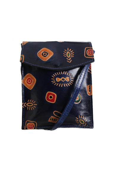 front of unlabeled blue navy print crossbody bag. features abstract print throughout, single crossbody strap, zip pocket at back, double interior compartments, flap top with snap button closure.  
