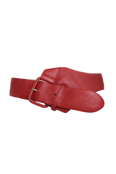 front of  unlabeled red leather wide belt. features contrast stitching, asymmetrical design, and rectangular shape buckle closure.