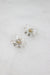 angled top view of clear cut beaded earrings facing up highlighting white crystal center stud detail