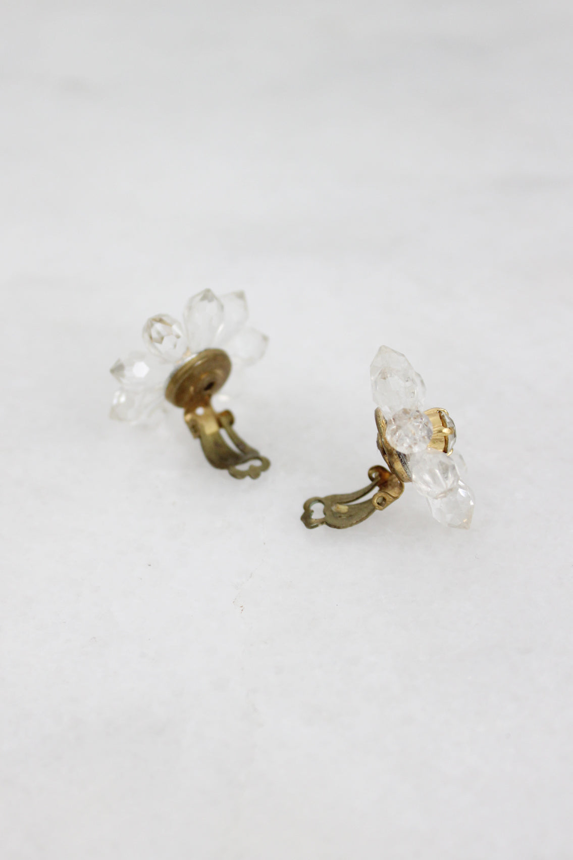 profile of clear beaded earrings showcasing open hinges