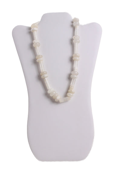 vintage white and clear beaded necklace on necklace placard. features round and tubular beads with a twist clasp. 