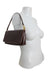 profile of bag positioned at mannequin torso. 