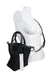 ¾ front profile of black mini tote staged against a female dress form highlighting the adjustable crossbody shoulder strap. 