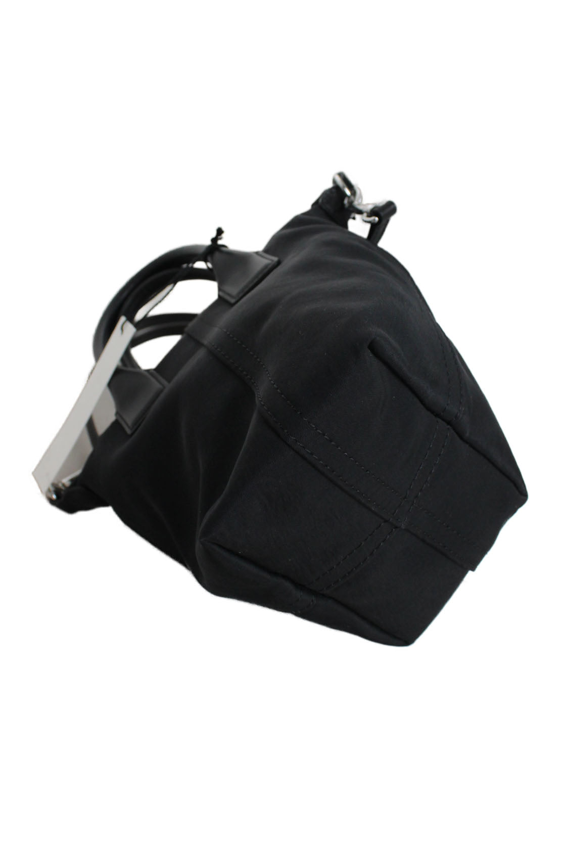 ¾ bottom view of black tote showcasing tapered shape. 