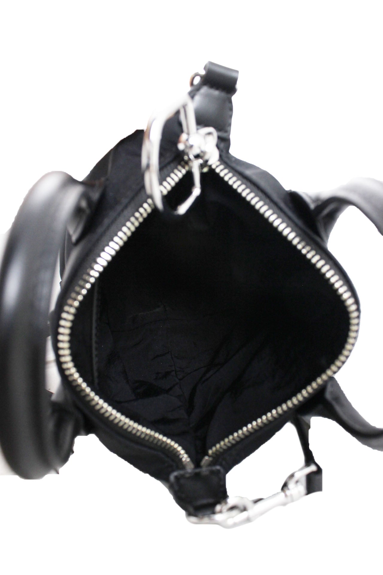 top view of black tote showcasing single compartment interior and the silver toned metallic hardware and top zipper closure. 