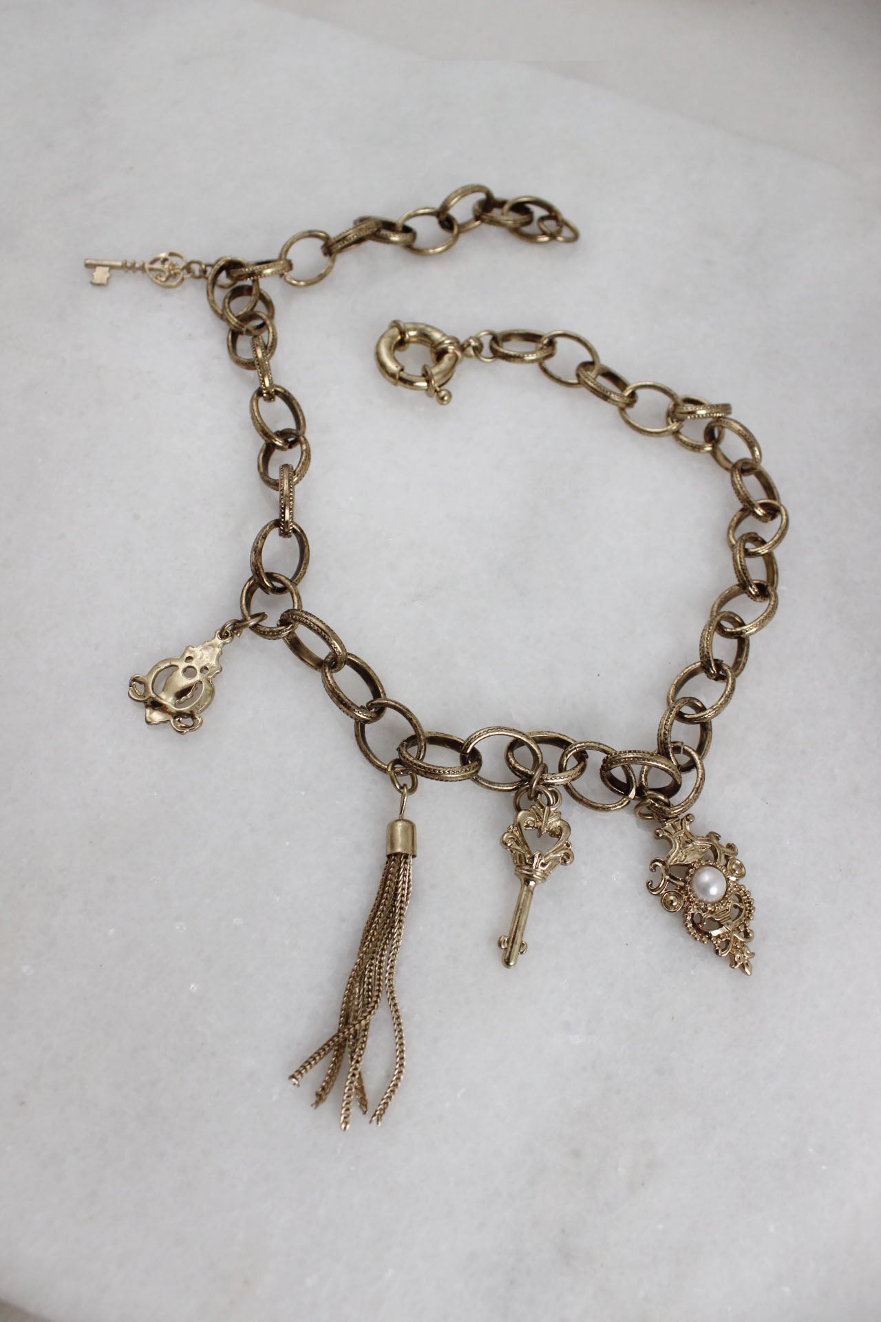 above angle of necklace with multiple charms. 
