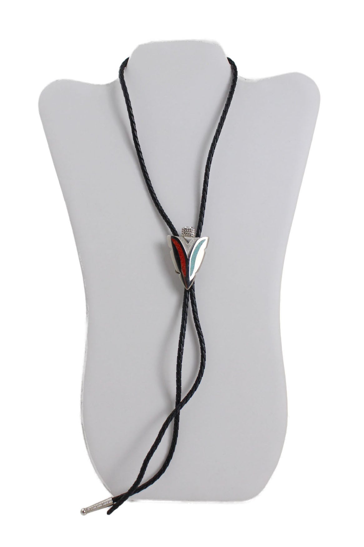 black braided leather-look bolo tie with a silver toned metallic arrowhead centerpiece adorned with turquoise and red stones staged on neck form. 