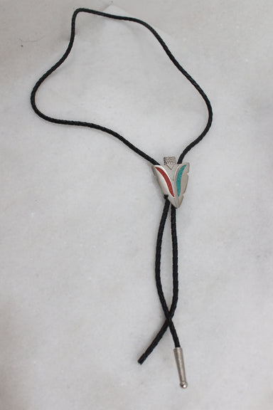 top view of bolo tie laid flat showcasing the missing metallic tip
