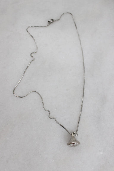 top view of silver toned metallic box chain necklace laid flat showcasing the textured pendant.  