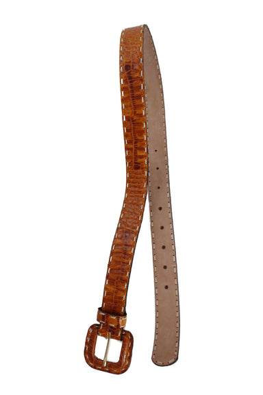 under angle of leather belt. features suede backing. 