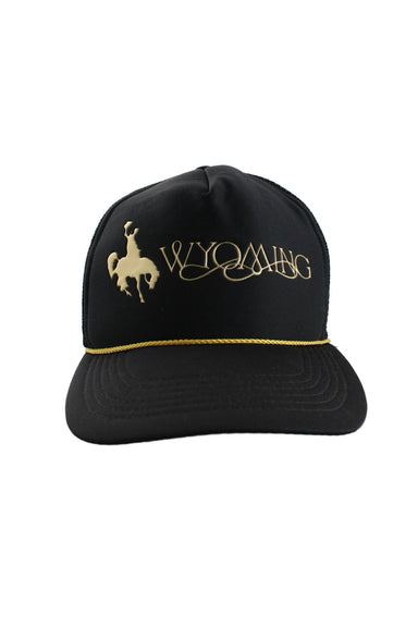 front angle of vintage black and gold wyoming trucker hat. features gold cord across brim and cowboy figure next to text 'wyoming' in gold embossment.