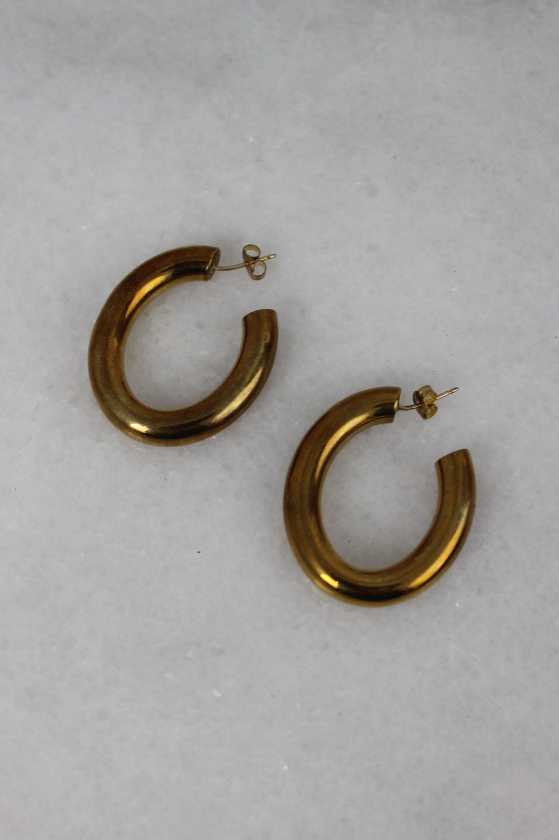 detailed shot of brass earrings. 