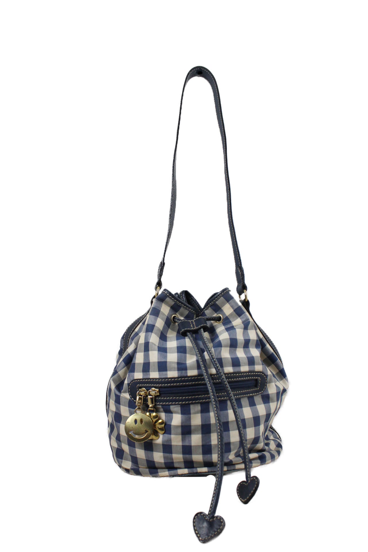 front of vintage moschino blue and white plaid bucket bag. features plaid design throughout, gold tone hardware, four leaf clover and smiley shape pendant, zip pockets, and drawstring closure with heart shape at edges. 