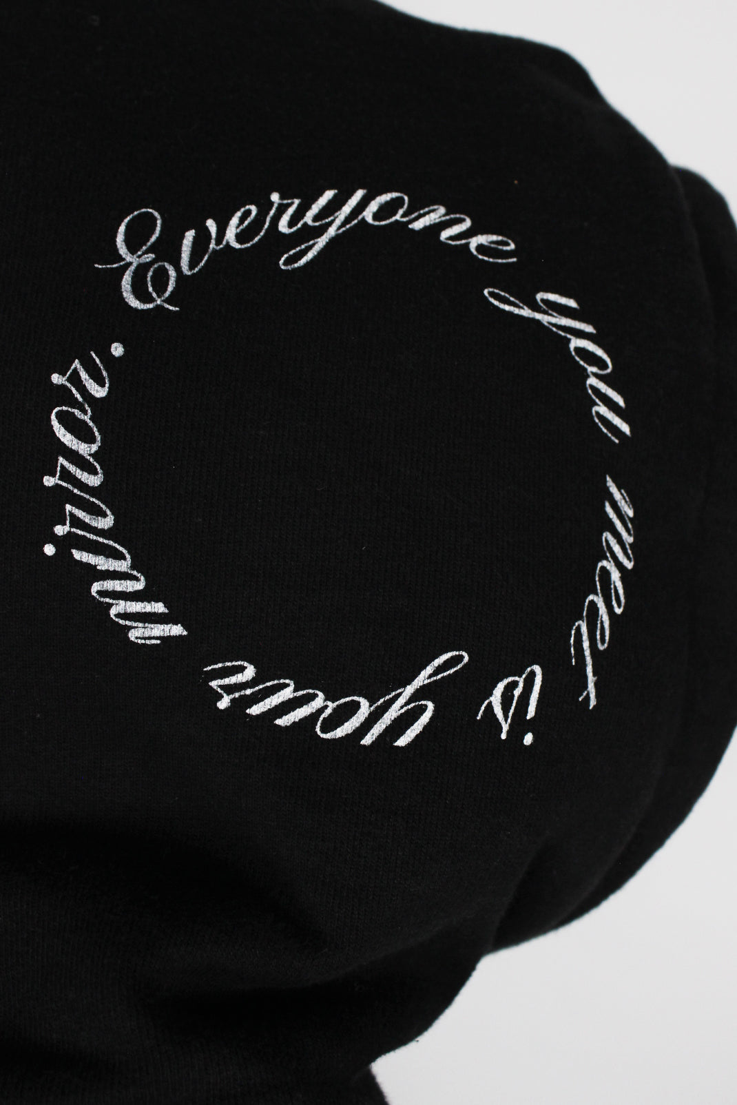 detail view with 'everyone you meet is you mirror.' graphic printed at right side of hood.